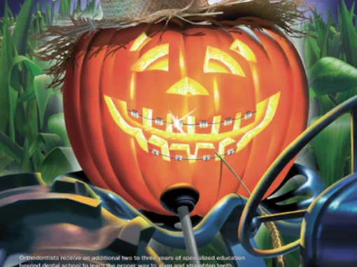 Smiling jack-o’-lantern with braces, wearing a straw hat, in front of a cornfield.