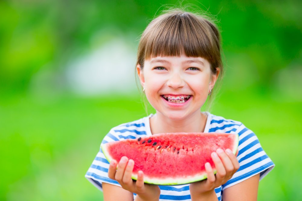 Girl with Braces Eating Watermelon