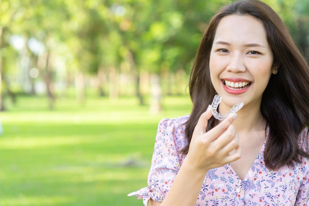 Woman using Invisalign - Advanced Orthodontics - August 18 Blog