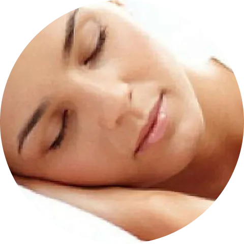 A woman with closed eyes rests her head on her hand, appearing peaceful and relaxed.
